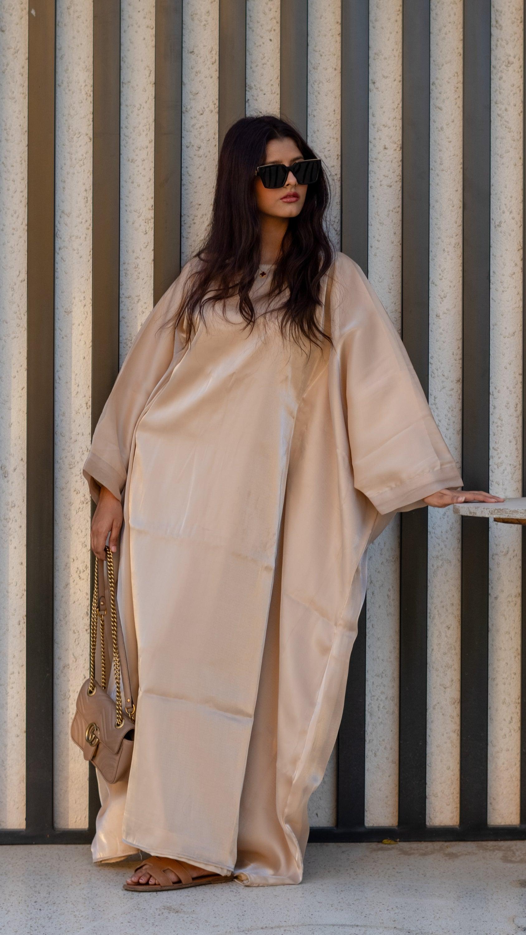 Model wearing a caramel butterfly abaya with flowy sleeves